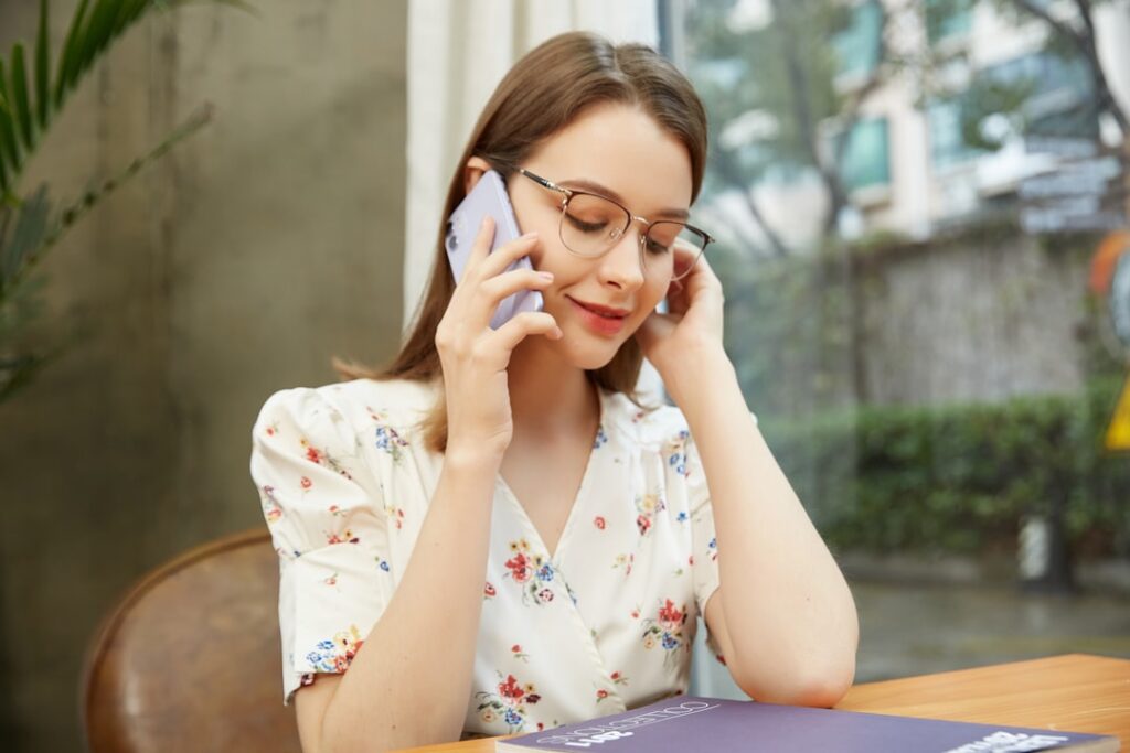 This image captures a young woman radiating confidence and charm while wearing a pair of stylish glasses. The lightweight frame complements her face, offering a perfect balance of elegance and functionality. Designed for everyday use, these glasses enhance both comfort and style, making them ideal for work, casual outings, or catching up on calls.