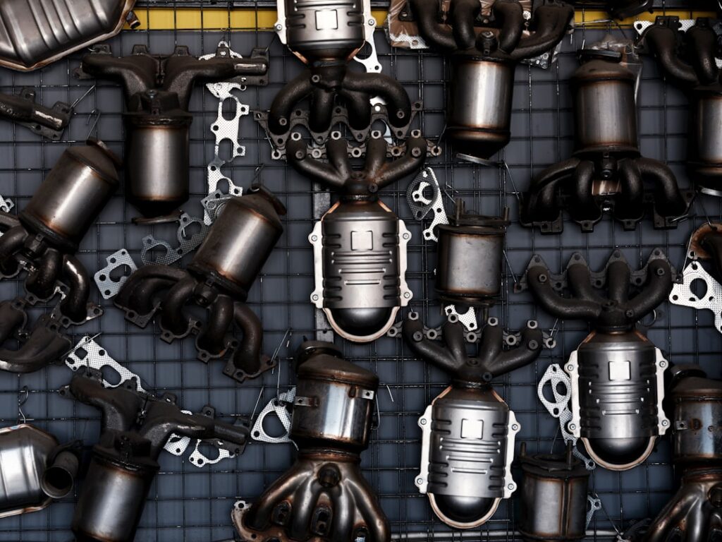 Industrial scene with used car exhaust systems on garage wall