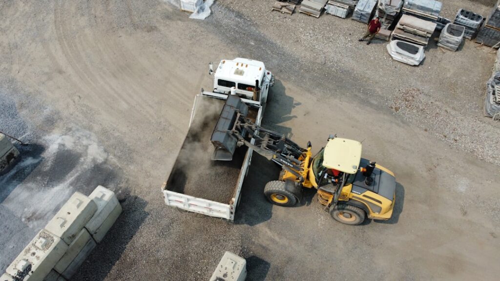 Aerial view of dirt being loaded into a truck at a landscaping supply centry in Calgary, Alberta, Canada.