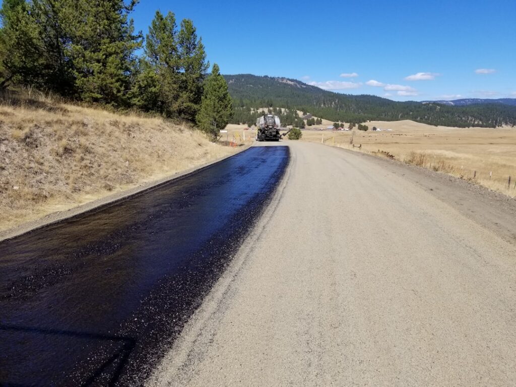 chip sealing a mountain road.
