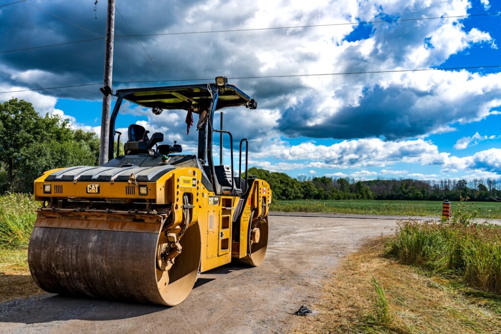 steam roller in the foreground with brilliant cloudy skies